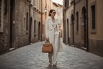 Woman carrying a structured Italian leather handbag
