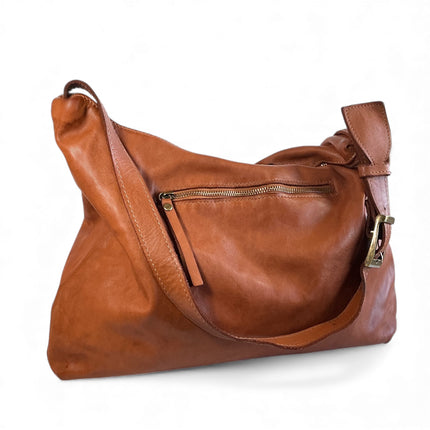 Brown leather handbag with antique gold tone zipper the back on a white background