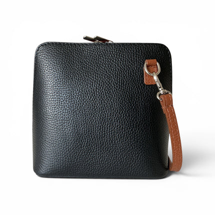 A two tone black and dark tan pebbled leather crossbody bag with a brown leather strap and silver-tone hardware, shown on a clean white background.