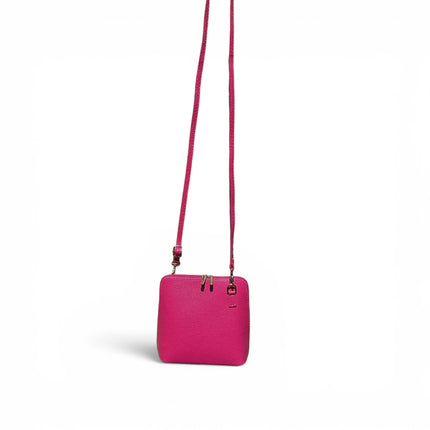 A bright pink pebbled leather crossbody bag with a matching pink strap and small silver-tone hardware, shown against a plain white background.
