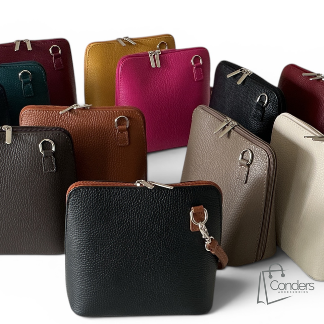 A group of pebbled leather zip-around crossbody bags in multiple colors, including black, brown, tan, beige, pink, magenta, mustard, teal, and burgundy, arranged on a white background. A Conders logo watermark is visible in the bottom right corner.