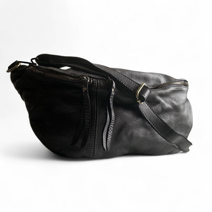 Black leather sling bag with a strap on a white background