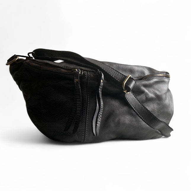 Black leather sling bag with a strap on a white background