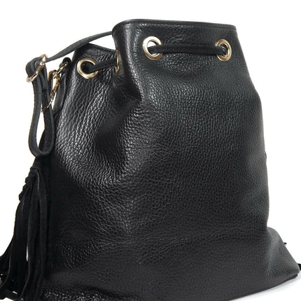 Back view of black leather and suede bucket bag with fringes. Drawstring closure