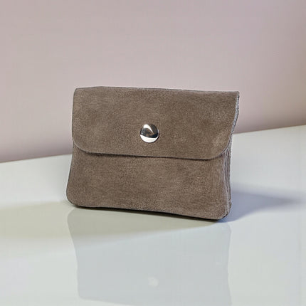 Brown suede coin purse with a silver button closure on a white surface.